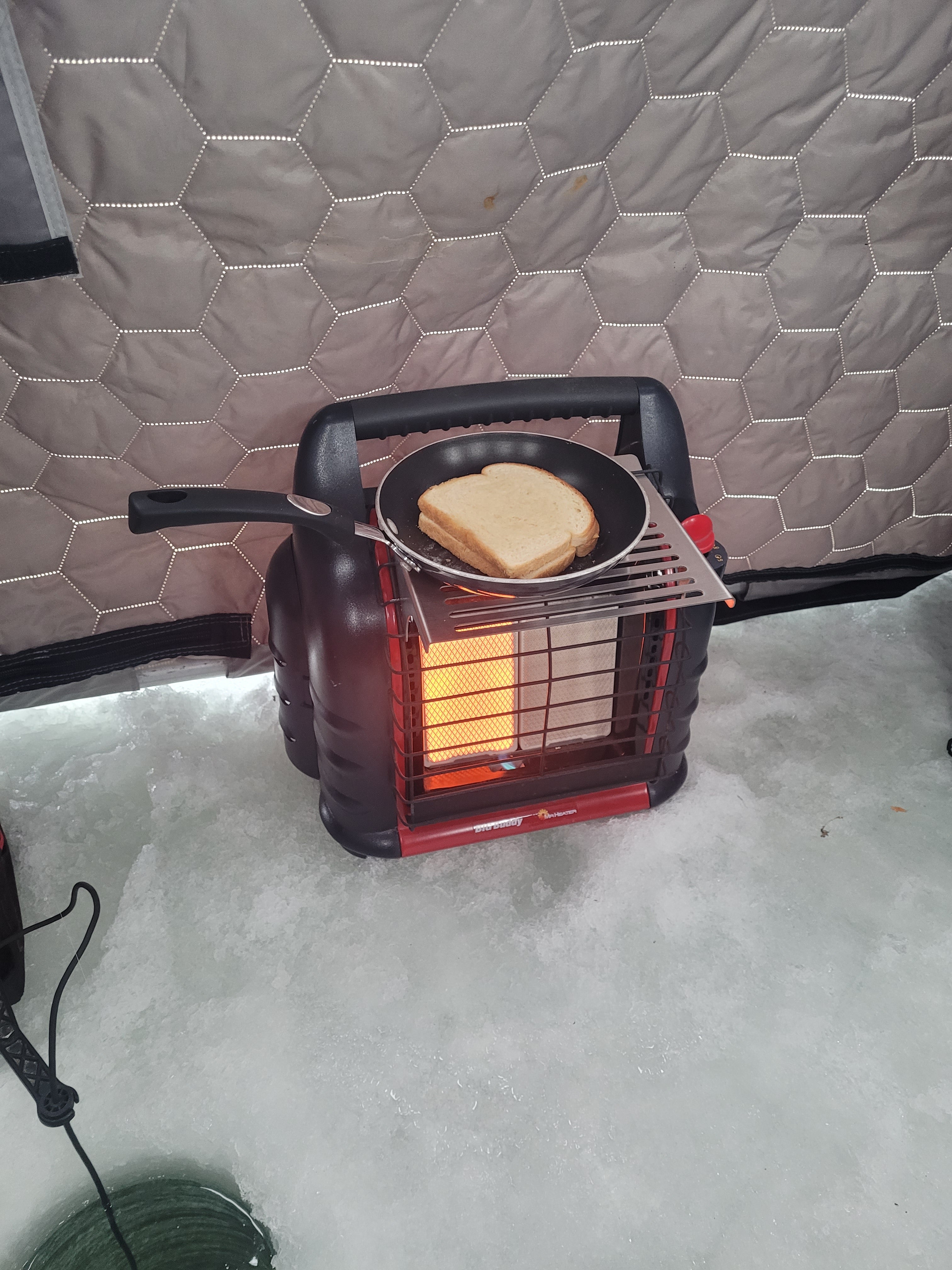 Portable heater with a pan on a ice